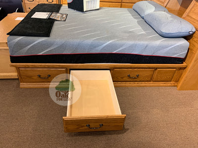 OD-O-T456 - Traditional Oak Pedestal Bed with 6 drawers pictured with a mattress and 2 pillows - side view with 1 drawer open - Oak For Less® Furniture